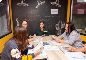 Three girls talking on class